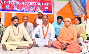 Saints and social activists sit on an agitation at Kankhal in support of hydropower projects in Uttarakhand in Haridwar on Tuesday.