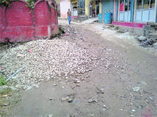 A potholed road in Palampur.