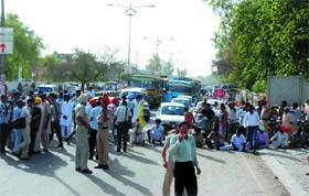 Kin of the labourer, who was killed while working in a trench on the Dabwali road on Tuesday, block the road near Bathinda Civil Hospital on Wednesday