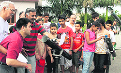 Students watch the transit of Venus in the sun through a telescope set up by the Uttarakhand Council of Science and Technology in Dehradun on Wednesday