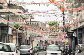 Code violation Buntings of political parties crisscross a road as candidate Sahrwan Grover puts up his poster on an electricity board in Ward 49 in Jalandhar