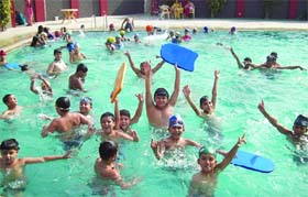Beating the heat Students of Delhi Public School enjoy in a swimming pool during a summer camp in Jalandhar