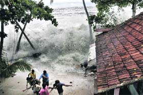Here comes the monsoon: People rush to safety after a storm at the Arabian Sea shores at Kannamaly in Kochi on Wednesday
