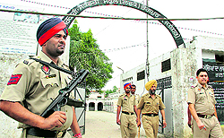 Police personnel outside a polling station in Bhogpur