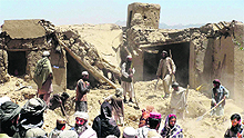 Villagers at the site of the pre-dawn NATO airstrike that killed civilians celebrating a wedding, including women and children, south of Kabul