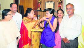 Poornima Mahajan, a student of BBK DAV College celebrate her success in Amritsar on Thursday