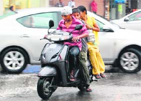 Rule breakers These underage drivers take traffic norms for a ride during rain in Amritsar on Thursday