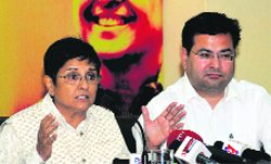 Kiran Bedi and Anshu Kataria, director of the Aryans Groups of Colleges, address the media at the PHD Chamber in Sector 31 of Chandigarh on Thursday.