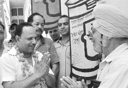 Rakesh Sharma, who is contesting the elections from ward number 37, greets a resident.