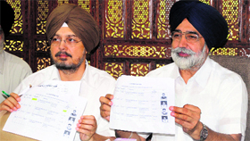 Punjab Education Minister Sikandar Singh Maluka (right) and officiating education secretary SS Channi declare the Punjab School Education Board class XII results in Mohali on Thursday.