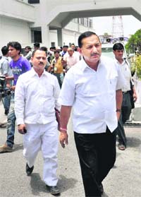 Congress MLA Mayukh Mehar (R) walks out of the Uttarakhand Assembly in Dehradun on Thursday