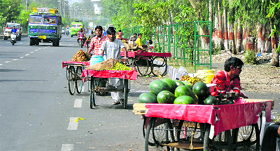 Vendors sell fruits on pushcarts on the busy BC Road in Jammu on Thursday.