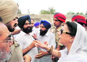 Akali workers argue with Congress MLA Karan Kaur Brar outside a polling station in Muktsar