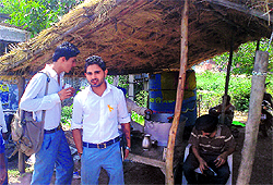 Students take shelter under a tea stall in Dera Bassi