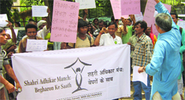 Homeless people protest outside DUSIB office in New Delhi on Friday.