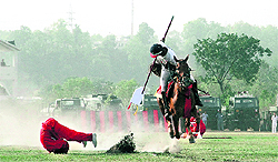 A gentleman cadet shows tent-pegging skills on the eve of the passing-out parade at the Indian Military Academy in Dehradun 
