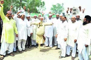 Members of the Muslim community protest at Gadarpur on Friday against the move of the Uttarakhand government to delay action against the alleged culprits of the Rudrapur riots. 