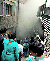 Smoke comes out from a private hotel in Shimla on Friday