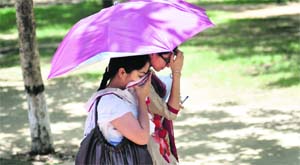Sudden rise in the temperature after cloudy weather forces these girls to shield themselves from the blazing sun in Ludhiana