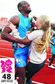 Usain Bolt, 100m Olympics champion, collides with a flower girl after winning the mens 100m at the IAAF Diamond League athletics meeting at the Bislett Stadium in Oslo on Thursday. 