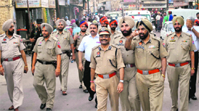 Policemen take out a flag march ahead of the MC elections in Patiala.