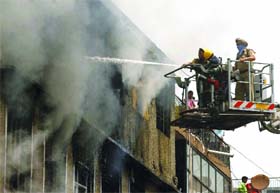 Firefighters douse the fire in the Bara Tuti area of Sadar Bazar in New Delhi on Saturday