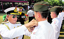 Navy Chief Admiral Nirmal Verma removes the covers of the stars of a foreign cadet after the passing-out parade at the Indian Military Academy in Dehradun on Saturday