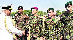 Navy Chief Admiral Nirmal Verma shakes hands with a cadet from Afghanistan at the Indian Military Academy in Dehradun on Saturday
