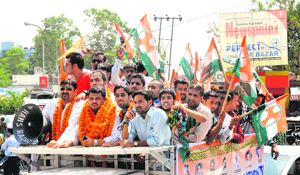 Members of the Pradesh Youth Congress participate in a rally to felicitate party vice-president Pranav Shagotra in Jammu on Saturday.