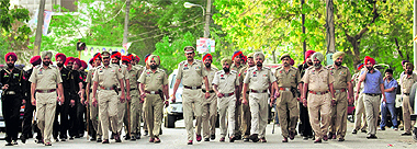 Policemen take out a flag march on the eve of Municipal Corporation elections in Ludhiana on Saturday. As many as 62 polling booths have been declared hypersensitive in Ludhiana