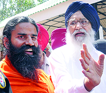 Punjab Chief Minister Parkash Singh Badal and yoga guru Baba Ramdev talk to mediapersons in Chandigarh on Saturday