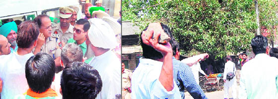 Deputy Commissioner Rajat Agarwal takes a round of the polling booths. A political activist pelt stones at his opponents during a scuffle during polling in Amritsar on Sunday. 
