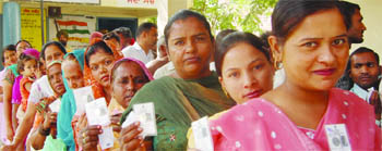 Voters stand in queues during polling in Amritsar on Sunday. 