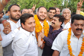 Babli and other Congress persons in a celebratory mode outside Ambedkar Bhawan after he was declared the winner of the by-election for Ward Number 6.
