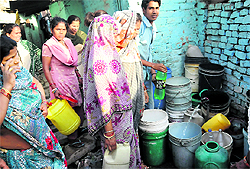 Residents of Colony No. 4 queue up for water from a public tap in Chandigarh on Sunday