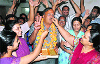 Anil Bajaj, Ward No 36 winner, is offered sweets
