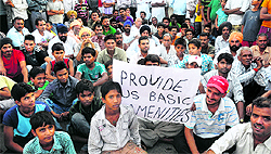 Residents of Hallo Majra protest against the Chandigarh Administration at the Hallo Majra light point in Chandigarh on Sunday
