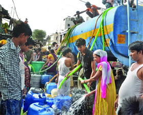 The residents of JJR Camp, Okhla Phase-II, collect water from a tank in New Delhi on Sunday.