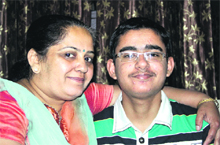 Vardaan Pahuja, who bagged first and third rank, respectively, in the district with their family members in Jalandhar. 