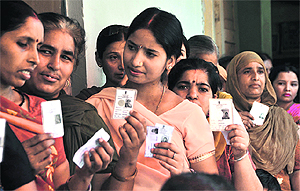 Voters show their identity cards during the polling for the municipal corporation elections in Ludhiana.