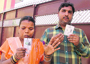 Basanti and Kali Parsad show their voter cards.