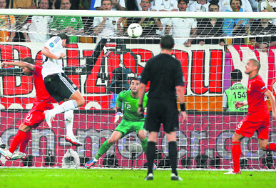 Germanys Mario Gomez (in white) scores the winner during the Group B match against Portugal in Lviv.
