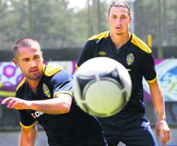 Zlatan Ibrahimovic (R) and Emir Bajrami warm up during a training session at Koncha Zaspa training centre near Kiev.