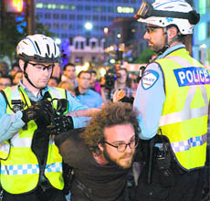 The police detains a university student during a protest in Montreal.