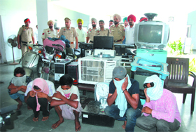 The five accused along with the stolen goods recovered by the police at the Civil Lines police station on Monday. 