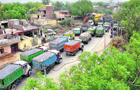 Residents of Pali village block traffic in protest against irregular electricity and water supply in Faridabad.