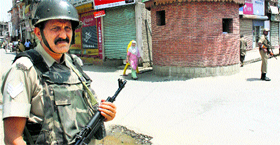 A CRPF jawan stands guard in Srinagar during a shutdown called by the hardline faction of the Hurriyat Conference on Monday.