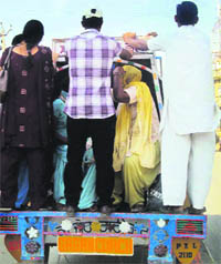A tempo operator ferries passengers on side and back stands at Jagraon. 