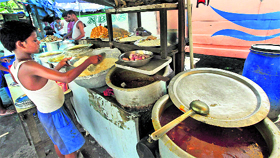 A child works at a food stall in Kolkata on the eve of 'International Child Labour Day' on Monday.