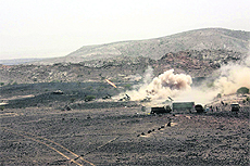 Yemeni army forces fire a missile towards positions of Al-Qaida-linked militants in Abyan. 